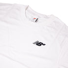 The New Balance Numeric Small Logo White Tee (MT53706WT) is a white cotton crewneck featuring a small black logo with motion lines on the left chest, a relaxed fit, and an internal collar tag.
