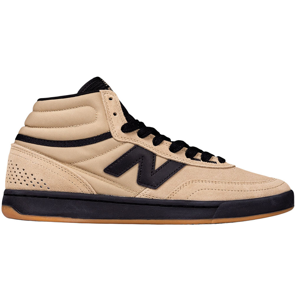 The 440 HAW New Balance Numeric Suede Skateboarding Shoes feature a beige high-top design with black laces, black accents, and a gum sole. Sporting a prominent black “N” logo on the side, these shoes are built for durability and performance as skate shoes, and include an ABZORB midsole for superior cushioning and impact protection.
