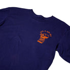 Jalopi Rip Off Blue Red Longsleeve Tee by Anti Hero Skateboards features an orange toilet paper roll graphic and the text “ITS A RIP-OFF” on the left chest, playfully referencing the brand’s classic style.