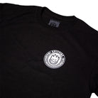 The Southside x Spitfire KTUL Pinwheel Black Tee features a black base with a small circular white Spitfire logo on the chest, showcasing a stylized grinning face and the word SPITFIRE above it—an iconic nod to underground lit pinwheel culture. A matching design is also found on the shirt tag, making this tee ideal for fans of Southside Skatepark and skate style.
