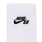 Close-up of a white fabric with a black embroidered Nike SB logo featuring the signature swoosh and stylized lettering, highlighting the premium design of the Nike SB Everyday Elevated 3 Pack IR1328910 White Black Crew Socks for all-day comfort.