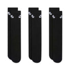 Three pairs of Nike SB Everyday Elevated Black White Crew Socks (3 Pack, style IR1328900) are laid flat side by side. Each black crew sock features a white Nike SB logo near the top and is crafted with Dri-FIT technology to help keep your feet cool and dry. The cushioned socks appear new and unworn against a white background.