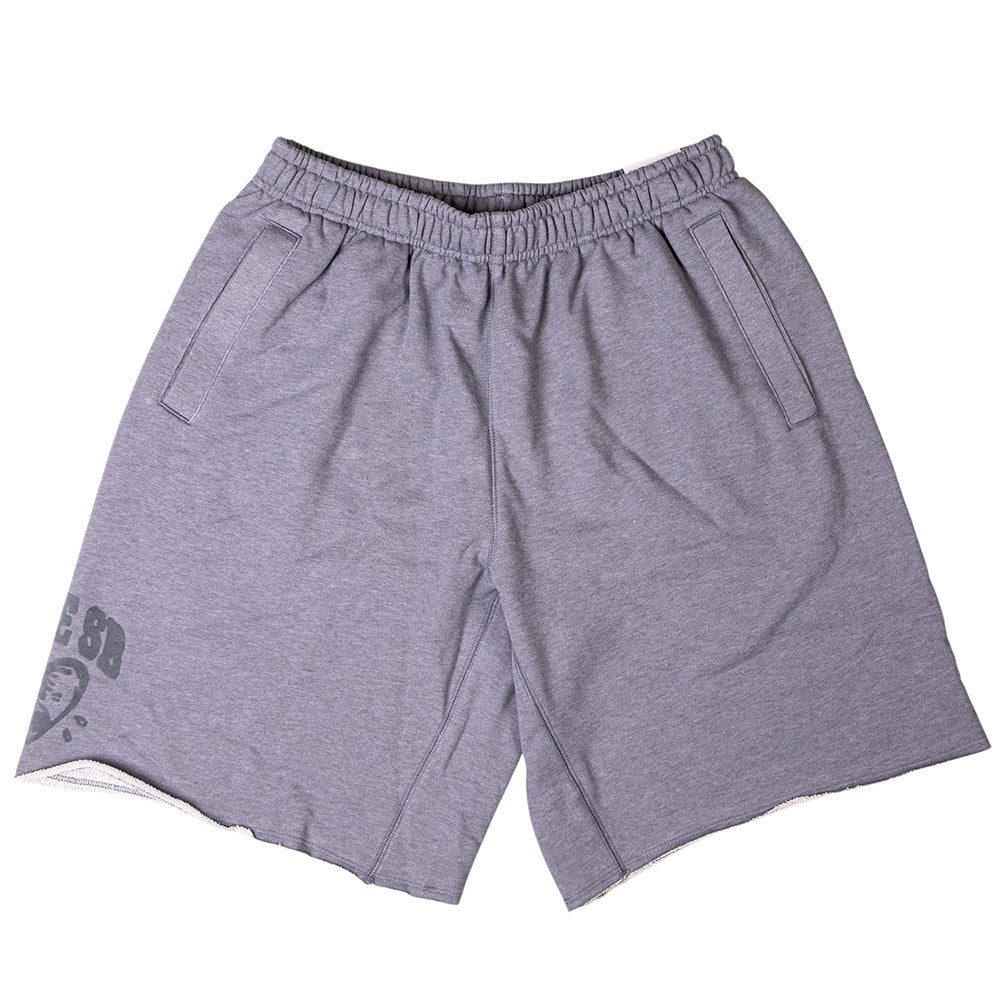 The IF1602065 Gray Sweat Short Skate Shorts Nike SB feature a loose fit, elastic waistband, side pockets, and a small dark logo on the lower left leg. These light gray shorts are machine washable for easy care.