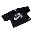 The Perforated Cropped Black Jersey IF1349010 is a Nike SB Skateboarding tee with short sleeves, a bold white NIKE SB logo and swoosh on the front, a blue/white label near the hem, and durable easy-care polyester mesh.
