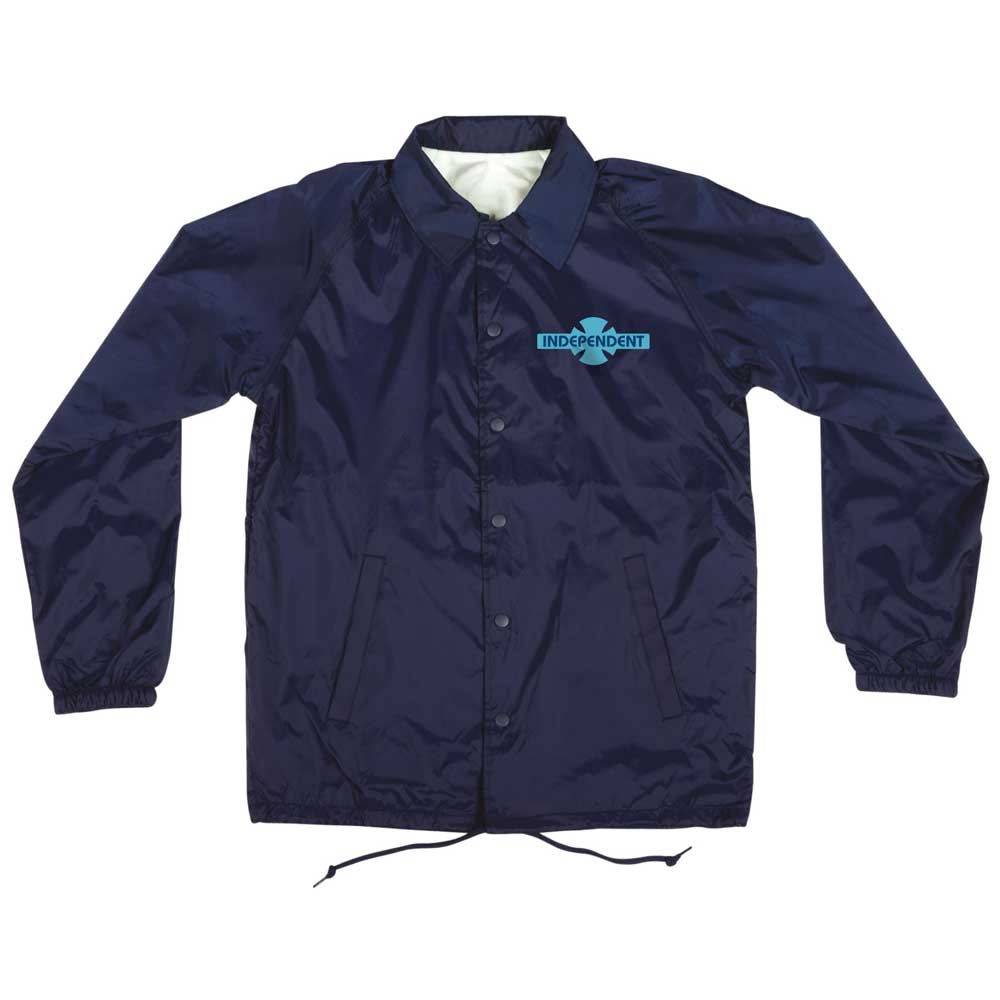 The OGBC Legacy Coach Windbreaker Longsleeve Jacket in navy blue features elastic cuffs, front pockets, and a small turquoise Independent logo—ideal for skateboarding and celebrating the Independent legacy.