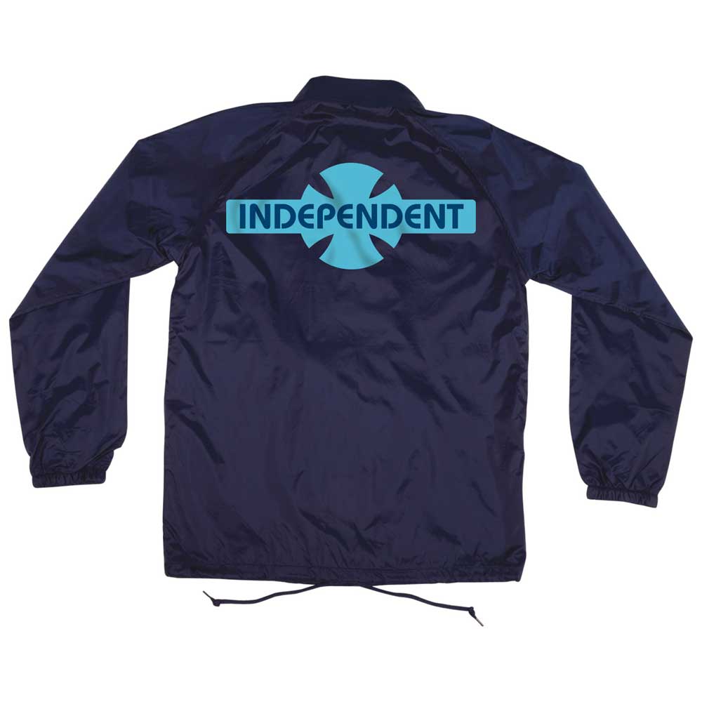 The OGBC Legacy Coach Windbreaker Longsleeve Jacket in navy blue for men by Independent features a turquoise Legacy logo and cross design on the back, with elastic cuffs, long sleeves, and a drawstring hem.