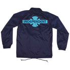 The OGBC Legacy Coach Windbreaker Longsleeve Jacket in navy blue for men by Independent features a turquoise Legacy logo and cross design on the back, with elastic cuffs, long sleeves, and a drawstring hem.