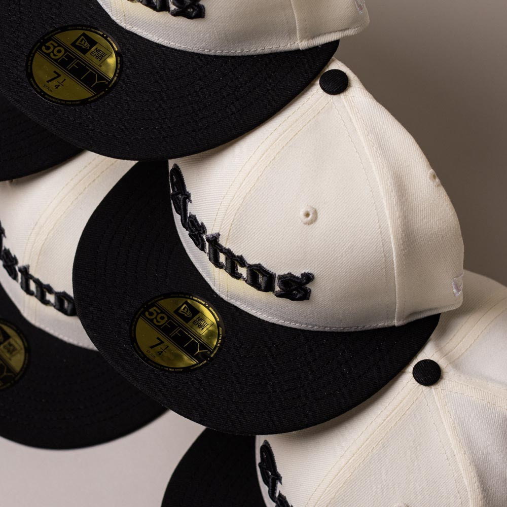 Four Straight Outta Southside OG Chrome Black Houston Astros New Era Hat 5950 Fitted caps with gold 59FIFTY stickers on the brims are arranged in a staggered row. Each cap showcases “Astros” embroidered in black on the front, embodying the iconic style of Houston Astros New Era fitted hats.