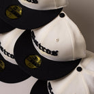 Four Straight Outta Southside OG Chrome Black Houston Astros New Era Hat 5950 Fitted caps with gold 59FIFTY stickers on the brims are arranged in a staggered row. Each cap showcases “Astros” embroidered in black on the front, embodying the iconic style of Houston Astros New Era fitted hats.