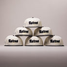 Six Straight Outta Southside OG Chrome Black Houston Astros New Era 5950 Fitted hats, each featuring the team name in bold black letters, are stacked in a pyramid shape against a plain, light background—a striking tribute to the Houston Astros and classic New Era hat style.