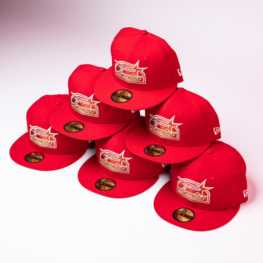 Seven H Town South Houston Astros New Era Hat 5950 Fitted caps in red, featuring gold and white embroidered logos, are stacked in a pyramid shape on a white background. Each hat has a sticker on the brim.