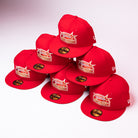 Seven H Town South Houston Astros New Era Hat 5950 Fitted caps in red, featuring gold and white embroidered logos, are stacked in a pyramid shape on a white background. Each hat has a sticker on the brim.