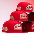 Four H Town South Houston Astros New Era 5950 Fitted hats are stacked in two piles. Each hat features the classic Astros logo and a brown Cooperstown Collection patch on the side, with a pinkish gradient background highlighting the signature fitted style.