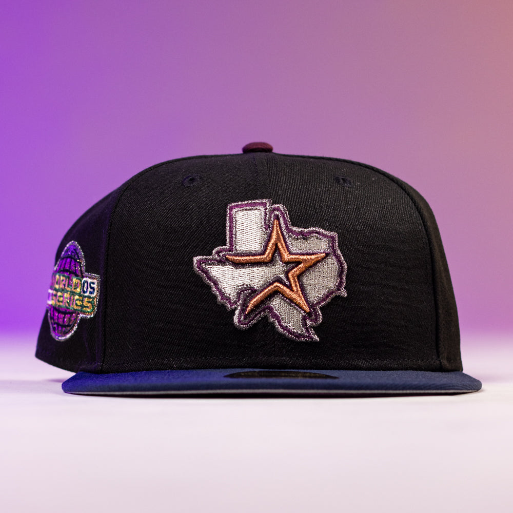 The Masterpiece WS05 Houston Astros New Era Hat 5950 Fitted is a black cap with an embroidered Texas outline and star on the front, a vibrant World Series patch on the side, set against a purple gradient background.