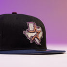 The Masterpiece WS05 Houston Astros New Era Hat 5950 Fitted is a black fitted cap with a flat brim, featuring an embroidered Texas outline and large star on the front, set against a purple gradient background.