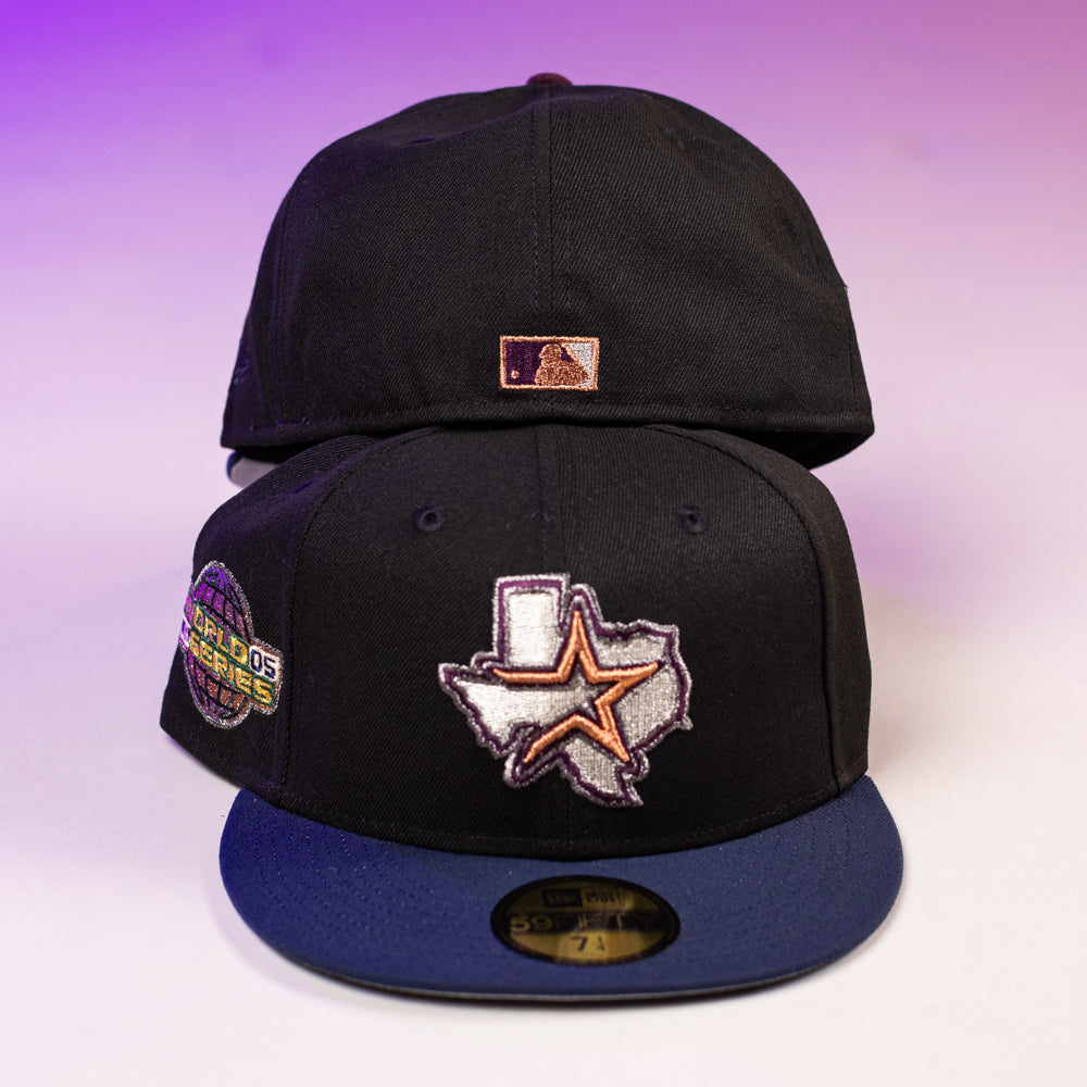 Two Masterpiece WS05 Houston Astros New Era Hat 5950 Fitted caps are shown, one front and one back. The front features a Texas outline with star and globe patch; the back has a small rectangular patch, and both have a dark blue brim.