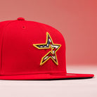 The Crest Lo 2.0 Houston Astros New Era Hat 5950 Fitted is a red cap with a yellow-trimmed star logo on the front featuring an American flag pattern inside the star, shown on a matching red background.
