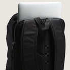 A close-up of the Obstacle Skatepack Backpack VN0A3I696ZC1 Black Ripstop by Vans Skateboarding shows a laptop in the back compartment, with padded shoulder straps and mesh padding for comfort.