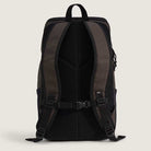 The Obstacle Skatepack Backpack VN0A3I69OVB1 in Brown Ripstop by Vans Skateboarding features padded shoulder straps, a chest buckle, breathable mesh back panel, and separate laptop compartment. The dark backpack stands upright against a light background.
