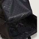 A close-up of the Obstacle Skatepack Backpack VN0A3I69OVB1 Brown Ripstop by Vans Skateboarding, showcasing its spacious, checkerboard-lined interior and zippered inner pocket.