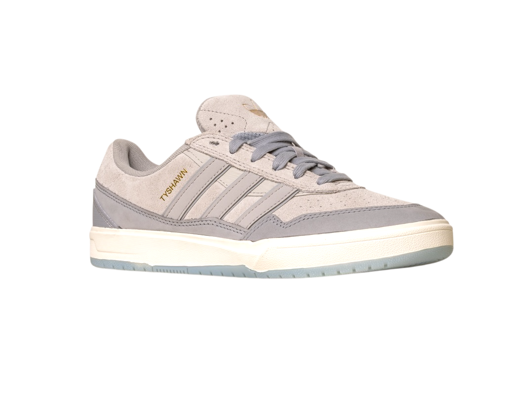 The JI0848 Granite White Tyshawn 2 II Adidas Skateboarding Shoe features gray and beige suede, three side stripes, a white midsole, TYSHAWN in gold, a light blue outsole, and is part of the Tyshawn II collection.