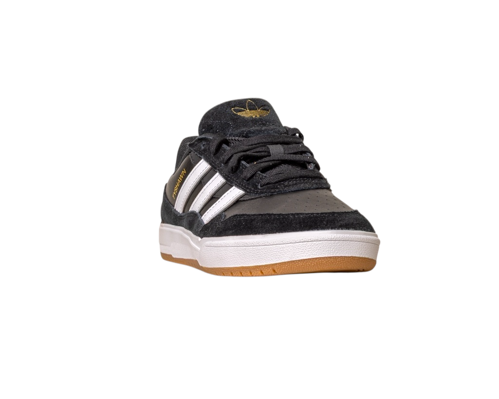 The JI 0846 Black White Gum Tyshawn 2 II Adidas Skateboarding Shoe features white stripes, gold branding, and a gum sole. Made with leather suede, it’s shown on a white background, angled to display its front and side.