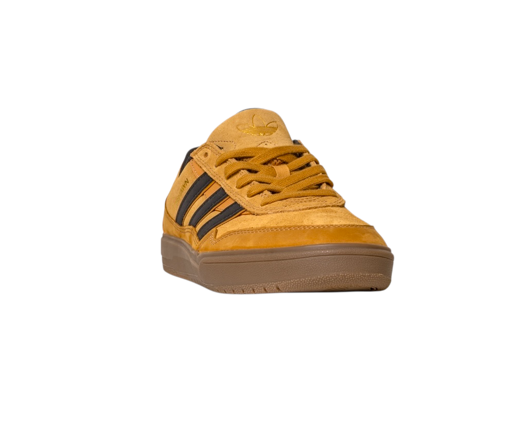 The JI0851 Mesa Black Gum Tyshawn 2 Adidas skateboarding shoe features mustard yellow leather and suede with black stripes, a brown cupsole, and is shown from a front angled view on a white background.