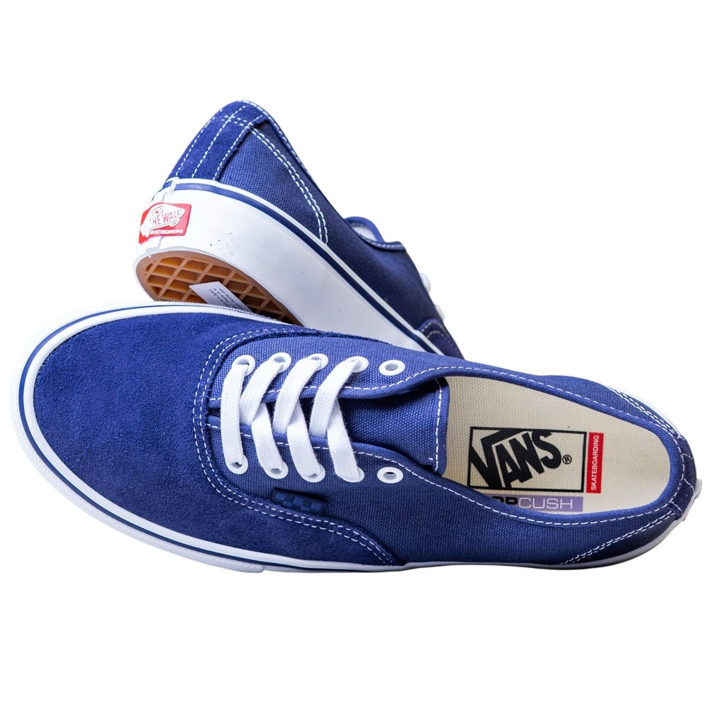 A pair of Skate Authentic Deep Twilight Vans VN000EEREMT1 suede white skateboarding shoes—one lies on its side showing the insole logo, the other propped up to display the gum outsole and red Vans heel tag.