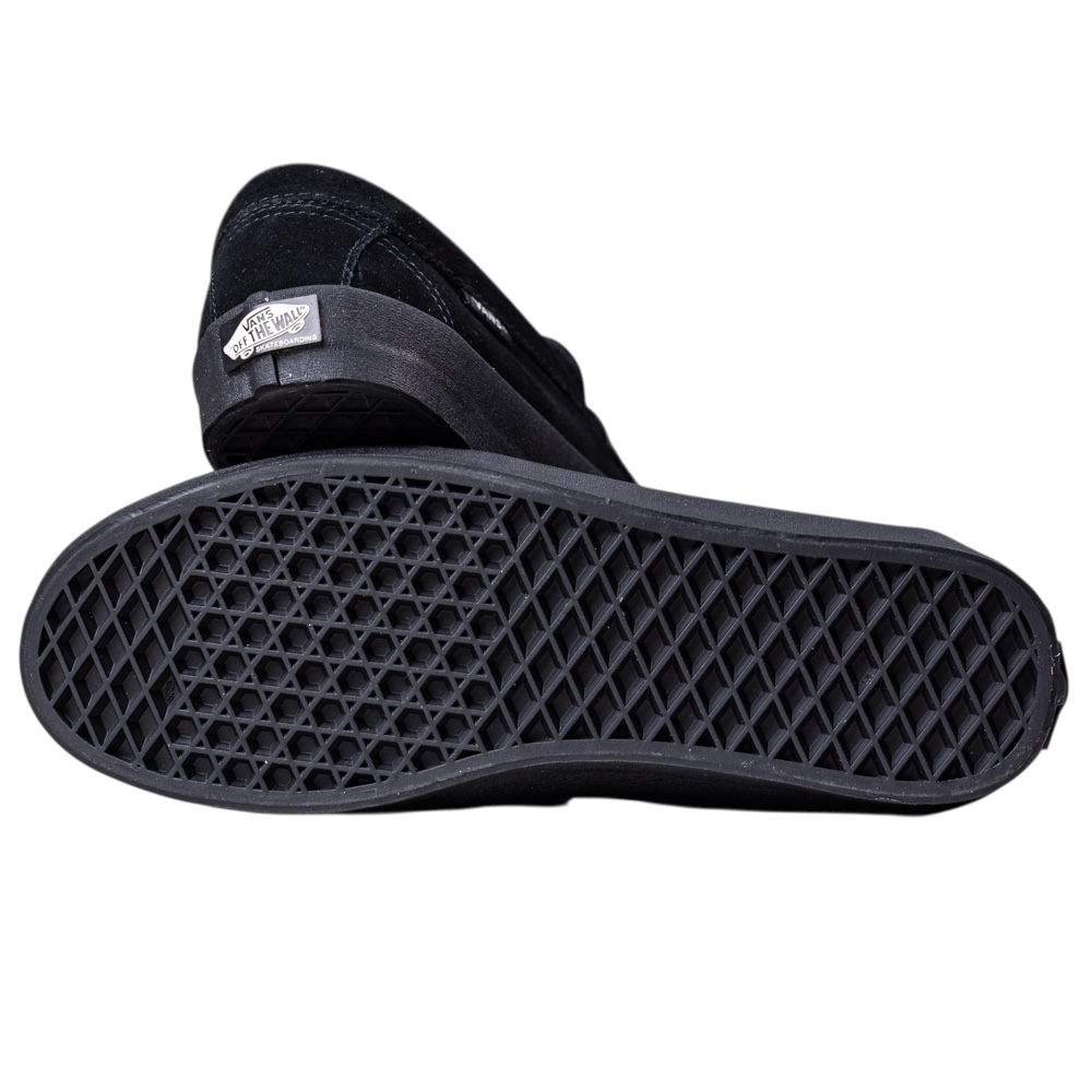 A pair of Skate Loafer Vans VN000VA6BKA1 Black Black Suede Skateboarding Shoes is shown: one lying on its side to display the waffle-patterned sole’s grip and impact protection, the other upright highlighting the Vans logo on the heel.