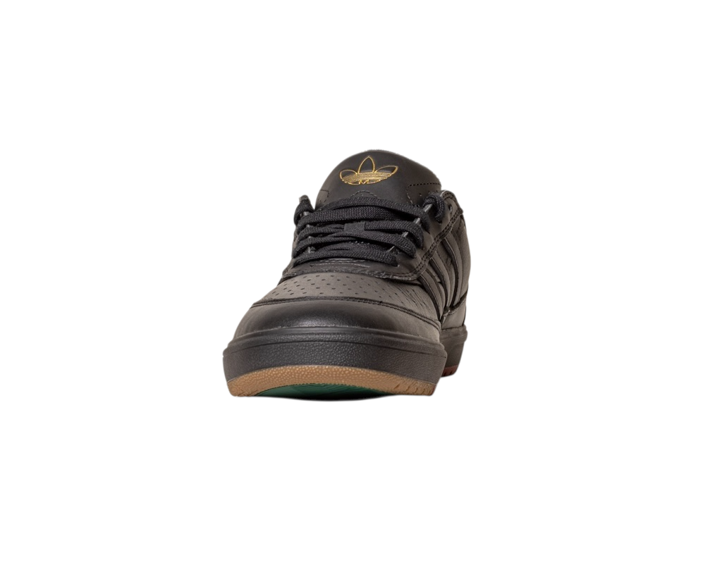 The Tyshawn 2 II Adidas Skateboarding Core Black/Core Green leather shoe features black laces, a gold Tyshawn II logo on the tongue, and a brown and green sole, shown from the front on a white background.