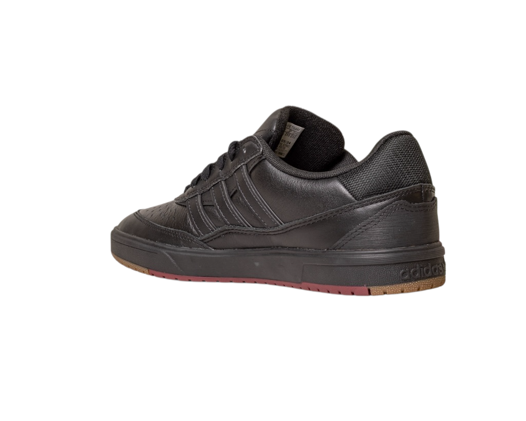 The Tyshawn 2 II Adidas Skateboarding Shoes feature a core black leather upper, low-top design, rubber sole, core green accents, textured detailing, and classic Adidas branding on the heel and sides, with a touch of brown on the outsole.