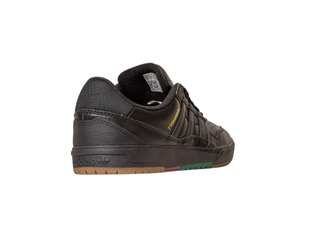 The Tyshawn 2 II Adidas Skateboarding Core Black/Core Green Leather Shoe, seen from the back left, features mesh and leather, a textured sole with brown and green accents, and "HANDBALL" in gold—a modern spin for skate shoe fans.