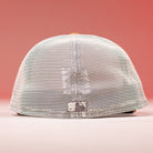 The 17WS Pink Trucker Houston Astros New Era Hat 5950 Fitted is shown from the back against a pink background, featuring a white mesh design, adjustable snap closure, and a small rectangular patch at the bottom center.