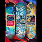 Three Pokemon TCG Blind Bag 8.0in x 31.6in Santa Cruz Decks featuring iridescent designs and large holographic-style illustrations of Xerneas, Vaporeon, and Pikachu & Zekrom Pokémon TCG cards.