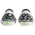 Back view of the Punk and Yo x Vans Skate Slip On VN000EKPY281 Canvas Shoes in black and white, featuring abstract doodle patterns and neon green Vans Off The Wall logos on the heels—a bold choice for skateboarding streetwear enthusiasts.