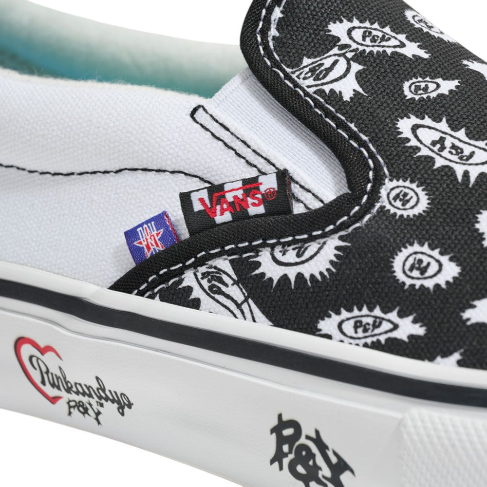Close-up of the Punk and Yo x Vans Skate Slip On VN000EKPY281 Canvas Shoes, highlighting the black and white paisley patterns, logo tags, and distinctive writing and graphics on the sole—making a bold statement in skateboarding streetwear culture.