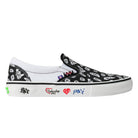 The Punk and Yo x Vans Skate Slip On VN000EKPY281 Canvas Shoes feature a black upper with white bandana-style patterns, a white sole, and vibrant graffiti-inspired designs and symbols along the side—a bold collaboration that blends classic Vans heritage with modern streetwear attitude.
