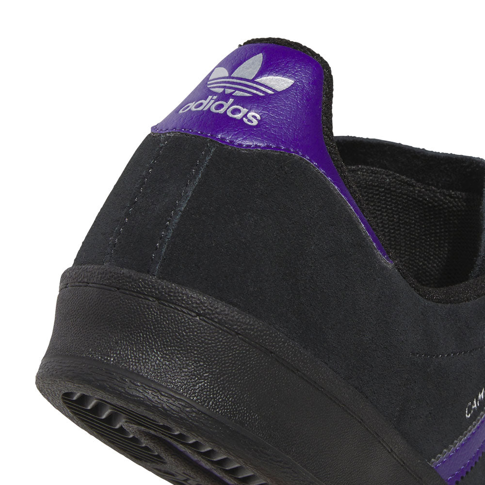 Close-up of the heel of the purple and black KK0247 Campus ADV Adidas Skateboarding suede leather shoe, featuring a purple accent and the white adidas trefoil logo on the back tab, highlighting its signature skate shoe style.