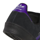 Close-up of the heel of the purple and black KK0247 Campus ADV Adidas Skateboarding suede leather shoe, featuring a purple accent and the white adidas trefoil logo on the back tab, highlighting its signature skate shoe style.