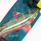 A close-up of the Raft Trout Landyachtz Complete Skateboard shows a wide cruiser deck with a realistic, colorful spotted fish illustration and "Landyachtz" scripted on the bottom left.