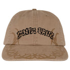 The Razor Arch Strip Hat is a tan, unstructured snapback from Independent Skateboards with black "Santa Cruz" text and a brown tribal pattern on the brim, offering a low-profile fit.
