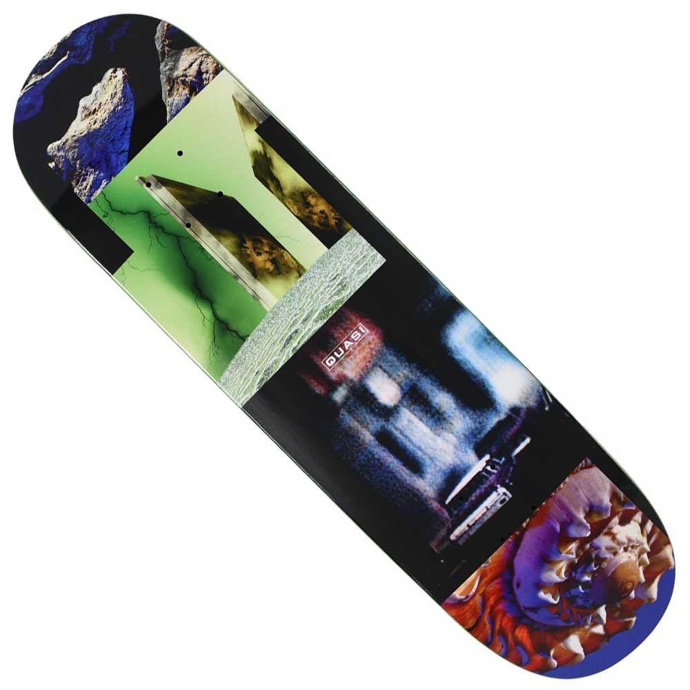 The Realms 8.5x31.8 Quasi Skateboards Deck Multicolor features a collage of abstract and surreal images, including jagged rocks, stone structures, bold green and blue blocks, metallic textures, and a close-up spiral seashell.