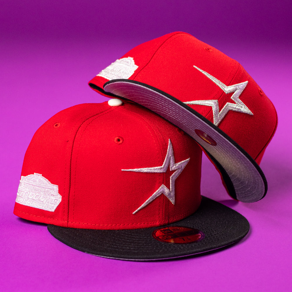 Two Sabor Fresa New Era Red Houston Astros 5950 fitted hats with silver star logos and commemorative patches are shown on a purple background—one upright, the other flipped to reveal “BuryMeInTheSouf” under the brim.