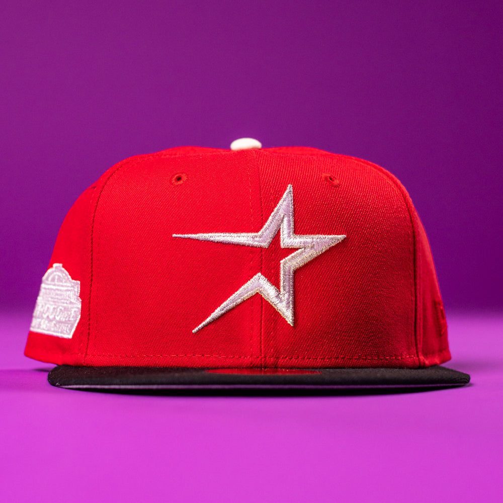 The Sabor Fresa New Era Red Houston Astros 5950 Fitted Hat features a silver star logo and black brim, shown on a bright purple background.