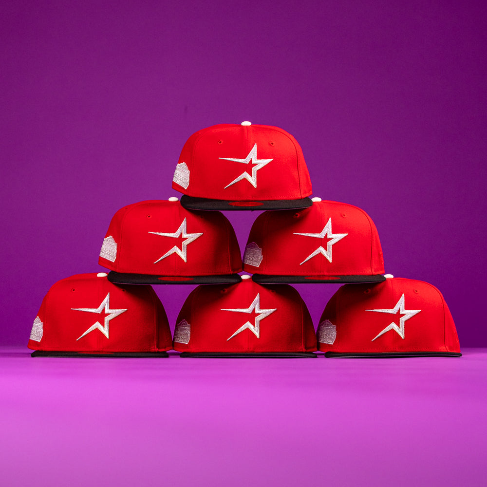 Six Sabor Fresa New Era Red Houston Astros 5950 Fitted hats, each featuring a white star logo, are arranged in a pyramid against a vibrant purple background, capturing true BuryMeInTheSouf vibes.