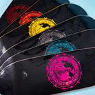 Five black Refinery Southside Skateboard Decks by Bigo are arranged in a fan shape, each featuring a colorful South Houston Skatepark logo with a stained veneer icon, showcasing the signature style of Southside Skatepark.