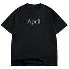 The Rhinestone Tee Black April Skateboards T-Shirt features "April" in white serif font at the front center, crafted from 100% cotton for comfort and durability.