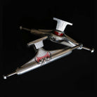 A set of two Rhino Span Polished Silver Standard INDY 169 Stage 11 Trucks are crossed, showcasing the Independent logo on a solid black background.