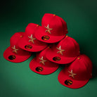 Six Rusty Screw OG Scarlet Copper Houston Astros New Era 5950 fitted hats are arranged in a pyramid stack on a green surface, with New Era brand stickers visible on the brims.