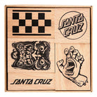 The SC Stamp Set Natural OS Unisex Santa Cruz includes four wooden blocks in a box, each engraved with unique designs: checkerboard, two Santa Cruz logos, a screaming face, and the iconic screaming hand—ideal for skateboard fans.